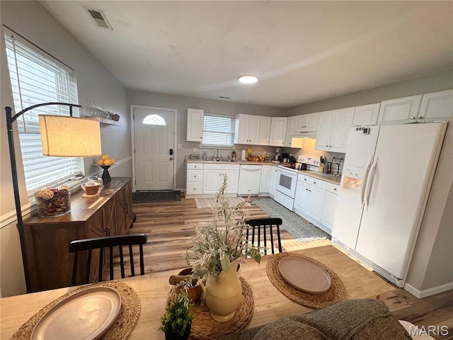 1319 W Church St, Bowling Green, MO 63334 - kitchen featuring white appliances, a sink, light wood finished floors, white cabinetry, and light countertops