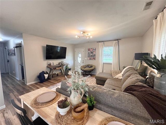 1319 W Church St, Bowling Green, MO 63334 - living room featuring wood finished floors, baseboards, and a chandelier