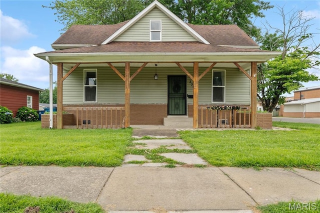 330 Elliott Ave, Chaffee, MO 63740 - view of front of property with a porch, roof with shingles, a front lawn, and brick siding
