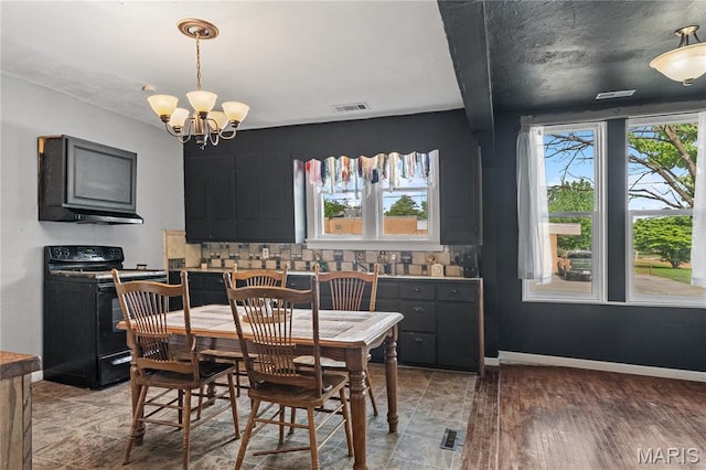 330 Elliott Ave, Chaffee, MO 63740 - dining space featuring healthy amount of natural light, a chandelier, and baseboards