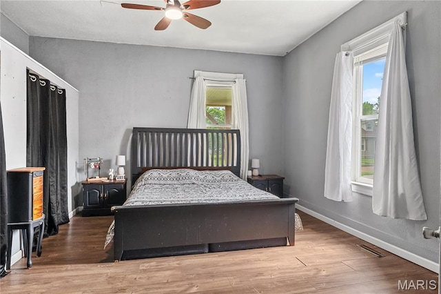 330 Elliott Ave, Chaffee, MO 63740 - bedroom with wood finished floors, baseboards, and ceiling fan