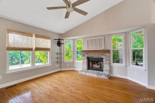 612 Hill Dr, Eureka, MO 63025 - unfurnished living room featuring plenty of natural light, wood finished floors, ceiling fan, a fireplace, and high vaulted ceiling