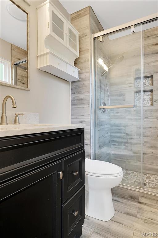 612 Hill Dr, Eureka, MO 63025 - bathroom featuring vanity, a shower stall, and wood finished floors