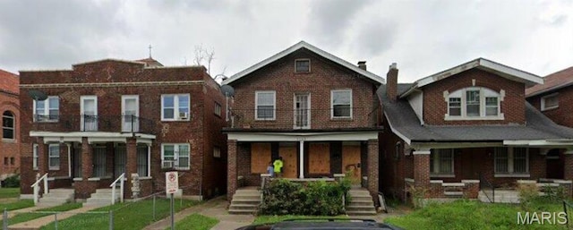 5104 Thekla Ave, Saint Louis, MO 63115 - view of front facade featuring covered porch, brick siding, and a chimney