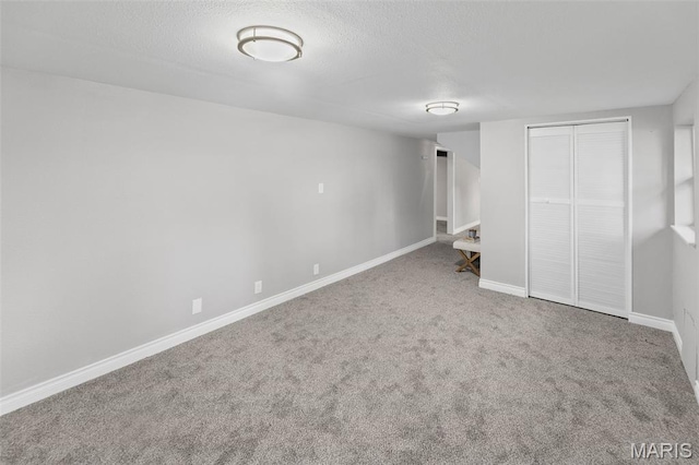 2012 Maple Tree Ln, Cahokia, IL 62206 - unfurnished bedroom with carpet floors, baseboards, a closet, and a textured ceiling