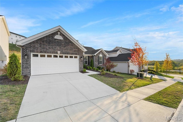 7405 Shadow Point Dr, Saint Louis, MO 63129 - ranch-style home featuring driveway, a garage, a front lawn, and brick siding