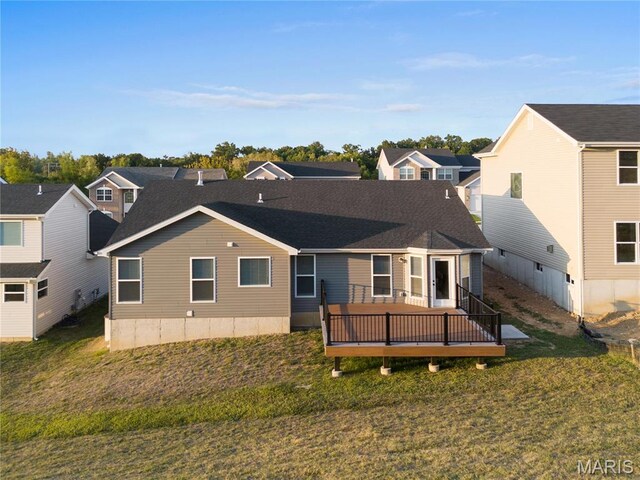 7405 Shadow Point Dr, Saint Louis, MO 63129 - back of house featuring a deck, a lawn, and a residential view