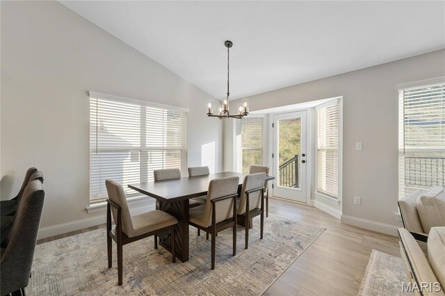 7405 Shadow Point Dr, Saint Louis, MO 63129 - dining room with a chandelier, lofted ceiling, baseboards, and light wood-type flooring