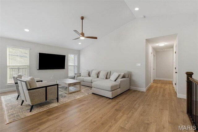 7405 Shadow Point Dr, Saint Louis, MO 63129 - living area featuring vaulted ceiling, ceiling fan, light wood-type flooring, healthy amount of natural light, and baseboards