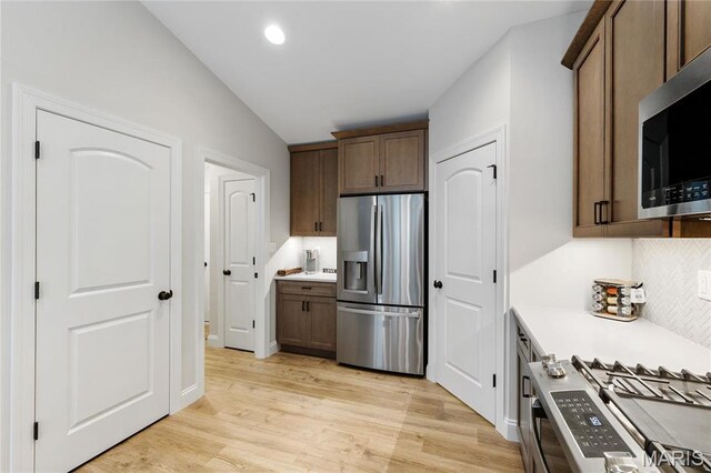 7405 Shadow Point Dr, Saint Louis, MO 63129 - kitchen with stainless steel appliances, lofted ceiling, light wood-type flooring, light countertops, and recessed lighting