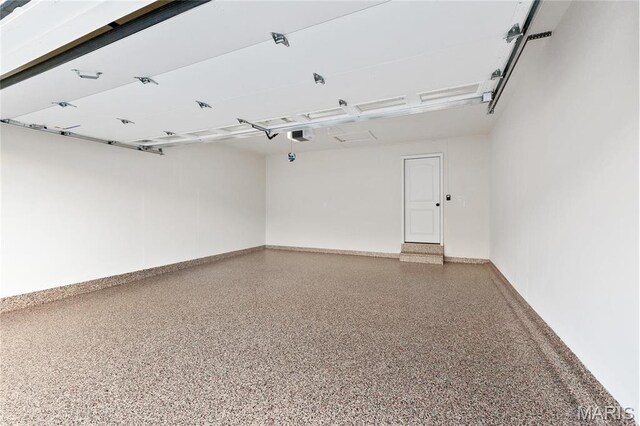 7405 Shadow Point Dr, Saint Louis, MO 63129 - garage with baseboards and a garage door opener