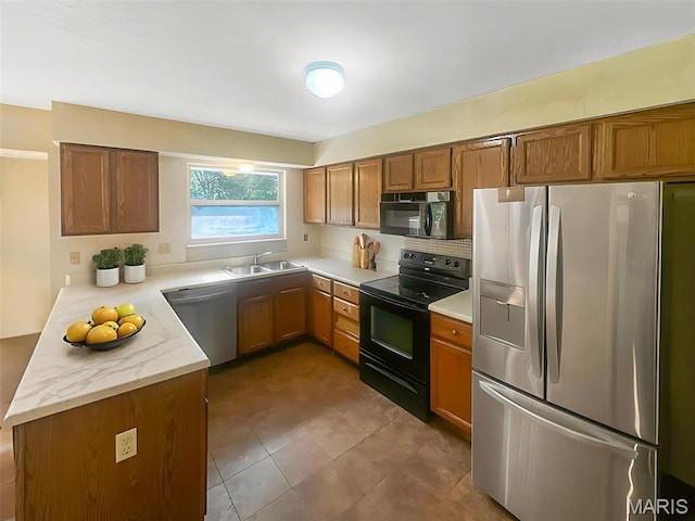 135 Misty View Ln, Saint Peters, MO 63376 - kitchen with black appliances, a sink, brown cabinetry, and a peninsula