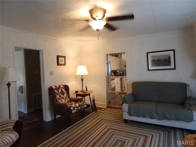 1620 W Centennial Ave, Bowling Green, MO 63334 - living room featuring ornamental molding, ceiling fan, baseboards, and wood finished floors