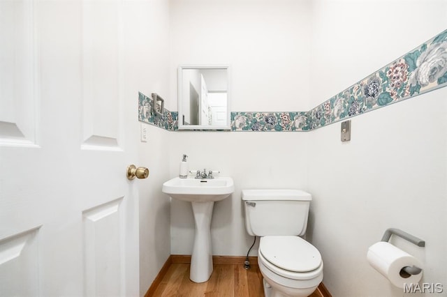 608 Andra Dr, Maryville, IL 62062 - half bathroom with toilet, wood finished floors, and a sink