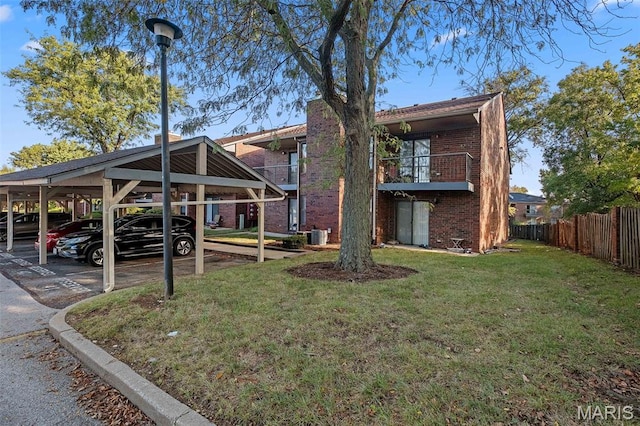 2339 Kratky Rd Unit A, Saint Louis, MO 63114 - rear view of house with brick siding, covered parking, a balcony, and central AC