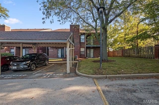 2339 Kratky Rd Unit A, Saint Louis, MO 63114 - view of front of house featuring covered parking, a chimney, brick siding, and a shingled roof