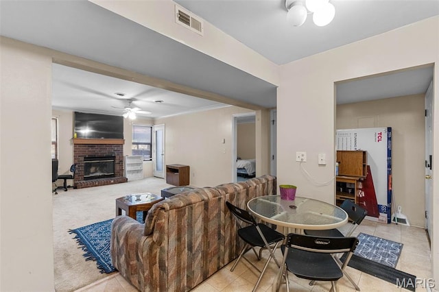 2339 Kratky Rd Unit A, Saint Louis, MO 63114 - living area featuring a ceiling fan, a brick fireplace, and tile patterned flooring