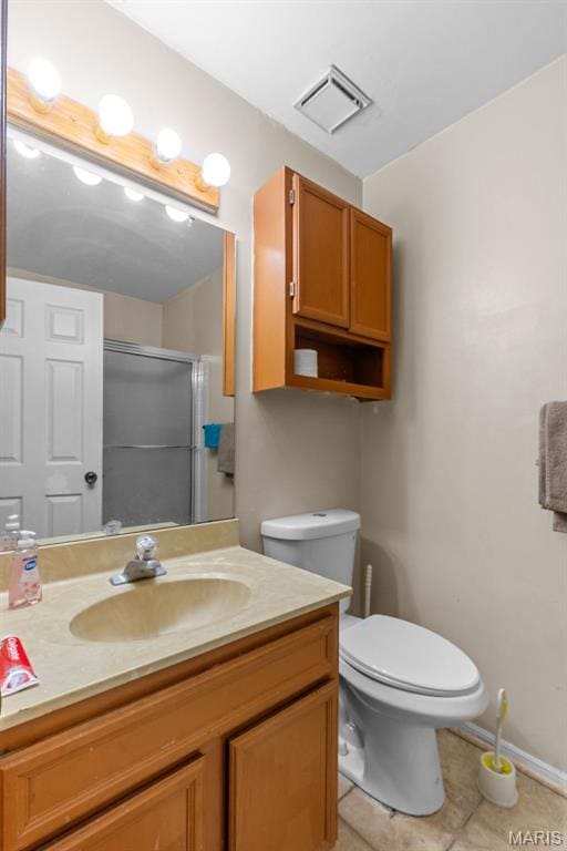 2339 Kratky Rd Unit A, Saint Louis, MO 63114 - bathroom featuring tile patterned floors, vanity, toilet, an enclosed shower, and baseboards
