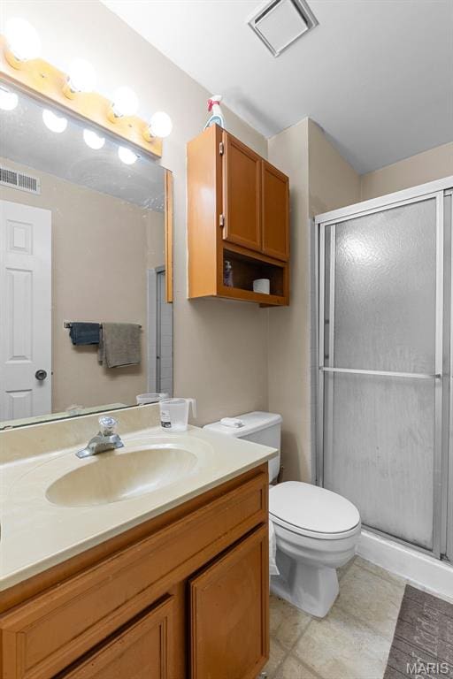 2339 Kratky Rd Unit A, Saint Louis, MO 63114 - bathroom featuring vanity, a stall shower, toilet, and tile patterned floors