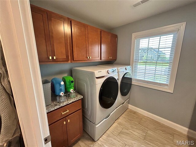 615 Jonathan Rd, Hannibal, MO 63401 - laundry area with independent washer and dryer, cabinet space, baseboards, and light marble finish floors