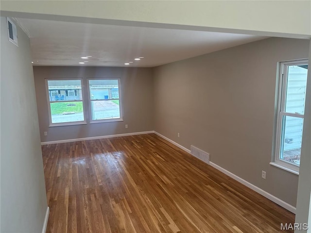 2542 Dukeland Dr, Ferguson Township, MO 63136 - empty room with wood finished floors, healthy amount of natural light, baseboards, and recessed lighting