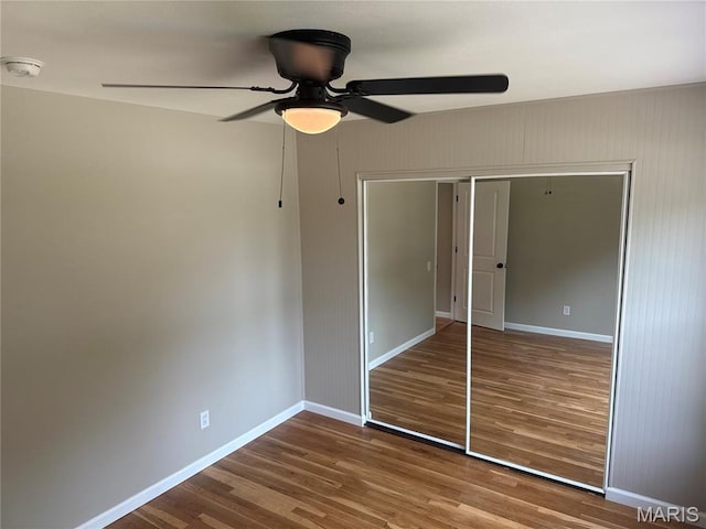 2542 Dukeland Dr, Ferguson Township, MO 63136 - unfurnished bedroom with wood finished floors, baseboards, a closet, and a ceiling fan