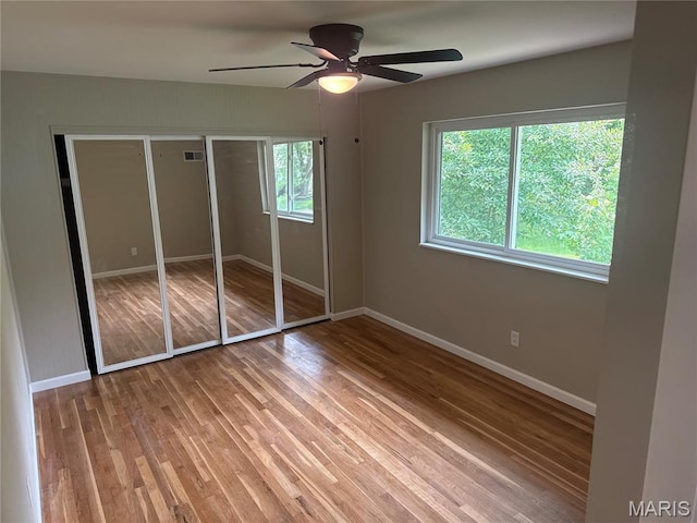 2542 Dukeland Dr, Ferguson Township, MO 63136 - unfurnished bedroom with baseboards, wood finished floors, a ceiling fan, and a closet
