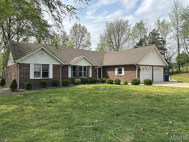 17273 Cedar Hills Dr, Dexter, MO 63841 - ranch-style home with brick siding, an attached garage, driveway, and a front yard