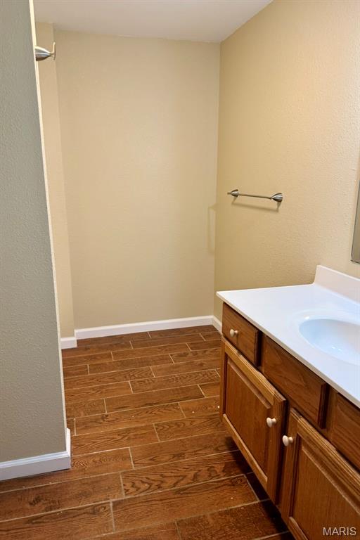 3936 State Highway 142, Doniphan, MO 63935 - bathroom with wood finished floors, vanity, and baseboards