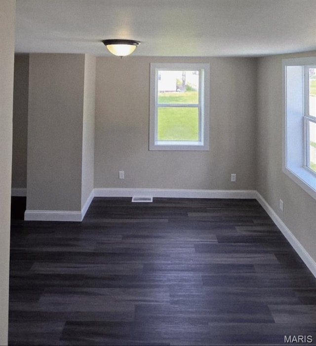 923 S High St, Belleville, IL 62220 - spare room featuring dark wood finished floors and baseboards