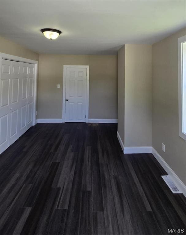 923 S High St, Belleville, IL 62220 - unfurnished bedroom featuring dark wood-style flooring and a closet