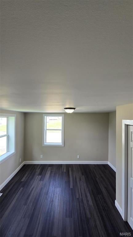 923 S High St, Belleville, IL 62220 - spare room with dark wood-style floors and a textured ceiling