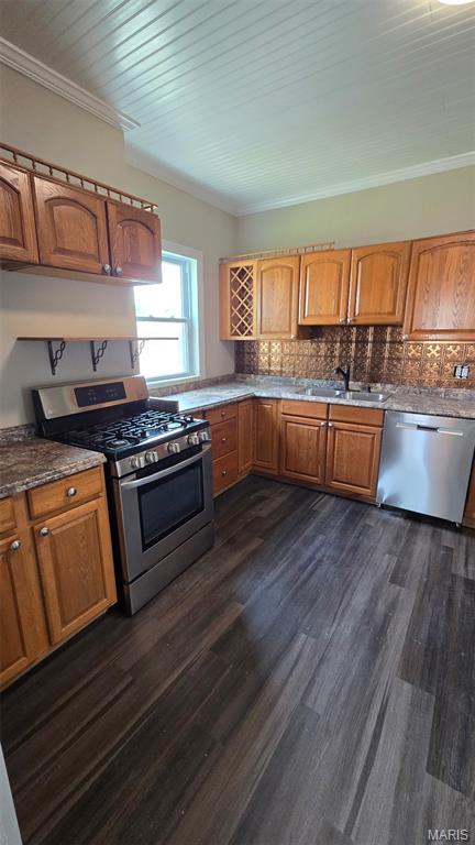 923 S High St, Belleville, IL 62220 - kitchen with stainless steel appliances, dark wood-type flooring, brown cabinetry, decorative backsplash, and ornamental molding