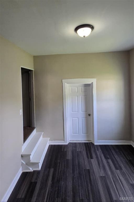 923 S High St, Belleville, IL 62220 - spare room with baseboards and dark wood finished floors