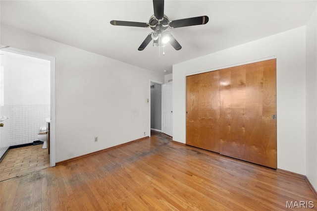 417 Concordia Ln, Saint Charles, MO 63301 - unfurnished bedroom featuring wood finished floors, ensuite bathroom, a closet, and a ceiling fan