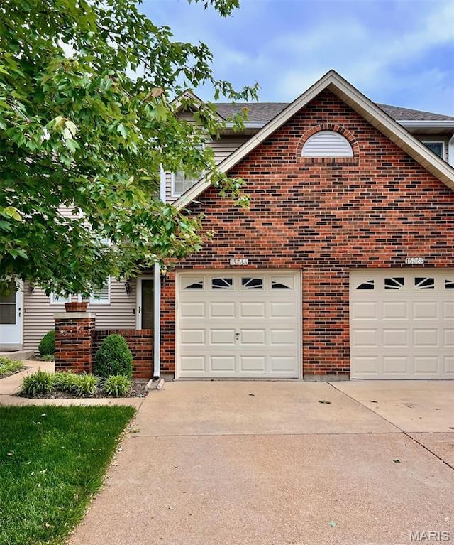 16266 Lea Oak Ct, Chesterfield, MO 63017 - view of front of house with driveway, brick siding, and a garage