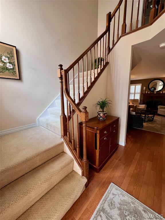 16266 Lea Oak Ct, Chesterfield, MO 63017 - staircase with wood finished floors