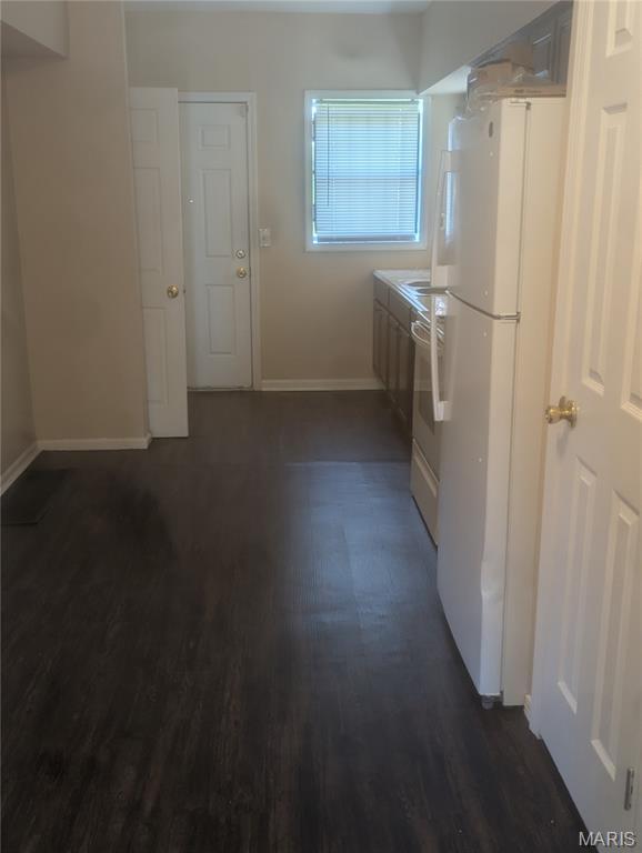 4737 Beacon Ave, Saint Louis, MO 63120 - laundry room featuring baseboards and dark wood-style flooring