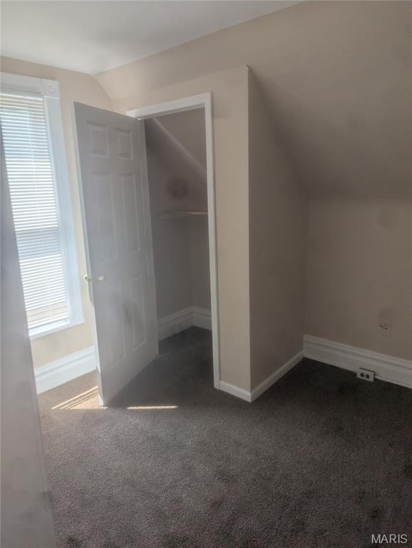4737 Beacon Ave, Saint Louis, MO 63120 - additional living space with vaulted ceiling and carpet flooring