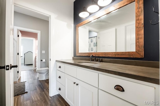 1821 Orr Ln, Ofallon, IL 62269 - bathroom with toilet, vanity, wood finished floors, and baseboards