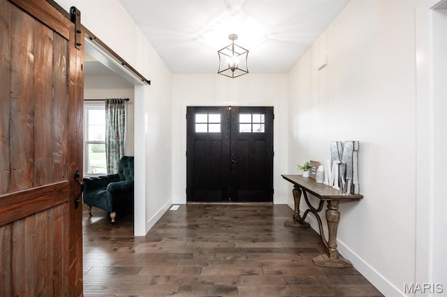 1821 Orr Ln, Ofallon, IL 62269 - foyer entrance featuring dark wood-style floors, baseboards, a barn door, and a chandelier