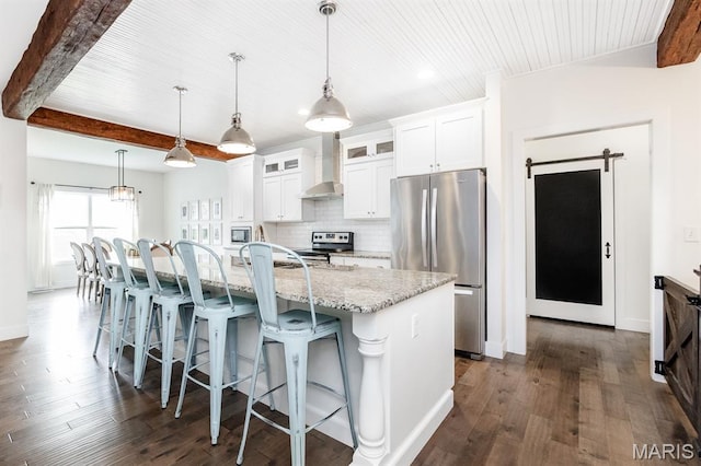 1821 Orr Ln, Ofallon, IL 62269 - kitchen featuring appliances with stainless steel finishes, wall chimney range hood, dark wood-type flooring, a breakfast bar area, and wooden ceiling with exposed beams
