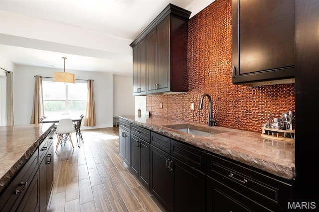 1821 Orr Ln, Ofallon, IL 62269 - kitchen with a sink, decorative backsplash, light wood-style flooring, and baseboards