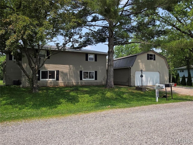 18835 Mary Jane Ln, Carlyle, IL 62231 - view of front of house featuring an outbuilding, a garage, a front yard, and a gambrel roof