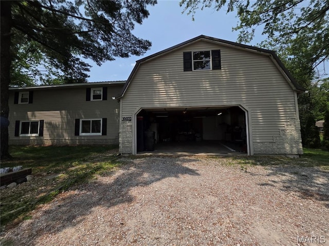 18835 Mary Jane Ln, Carlyle, IL 62231 - view of front of property featuring dirt driveway, stone siding, and a garage