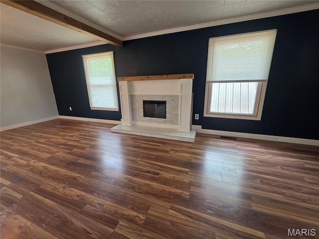 18835 Mary Jane Ln, Carlyle, IL 62231 - unfurnished living room with dark wood-type flooring, a tile fireplace, crown molding, and baseboards
