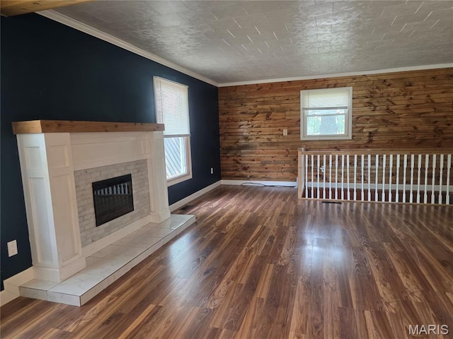 18835 Mary Jane Ln, Carlyle, IL 62231 - unfurnished living room with wood walls, wood finished floors, a fireplace, baseboards, and ornamental molding