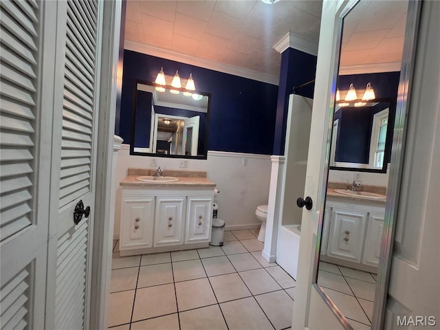 18835 Mary Jane Ln, Carlyle, IL 62231 - bathroom featuring toilet, vanity, crown molding, tile patterned floors, and a closet