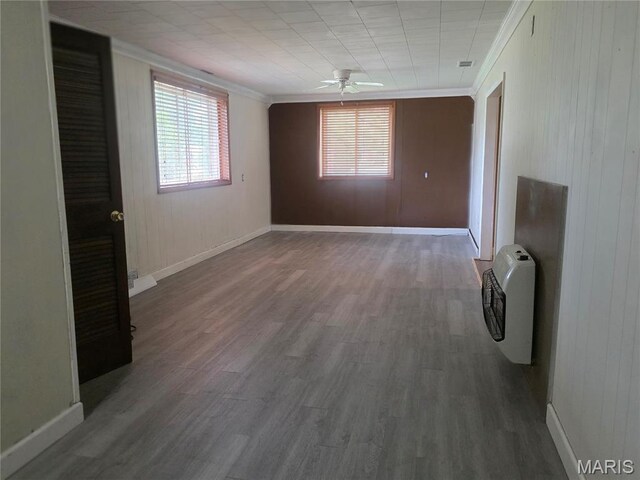 18835 Mary Jane Ln, Carlyle, IL 62231 - spare room featuring ornamental molding, wood finished floors, heating unit, plenty of natural light, and ceiling fan