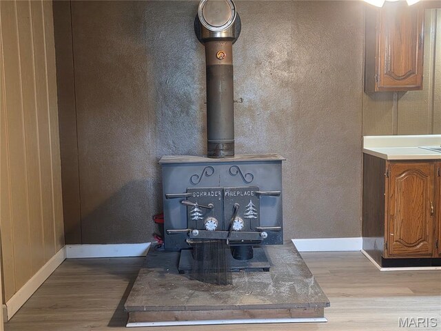 18835 Mary Jane Ln, Carlyle, IL 62231 - detailed view of a wood stove, wood finished floors, and baseboards